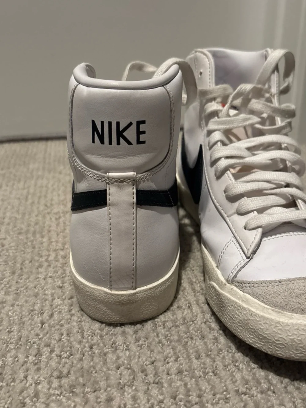 Nike White High-Top Sneakers with Black Swoosh